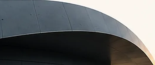 Curved architectural canopy in soft evening light